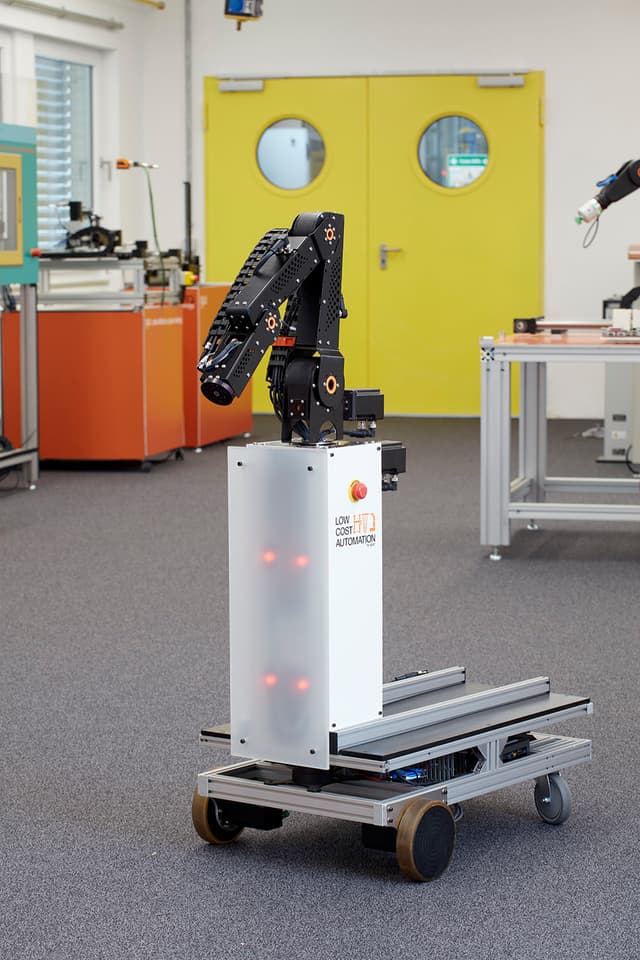 Driverless transport system with multi-axis articulated robot