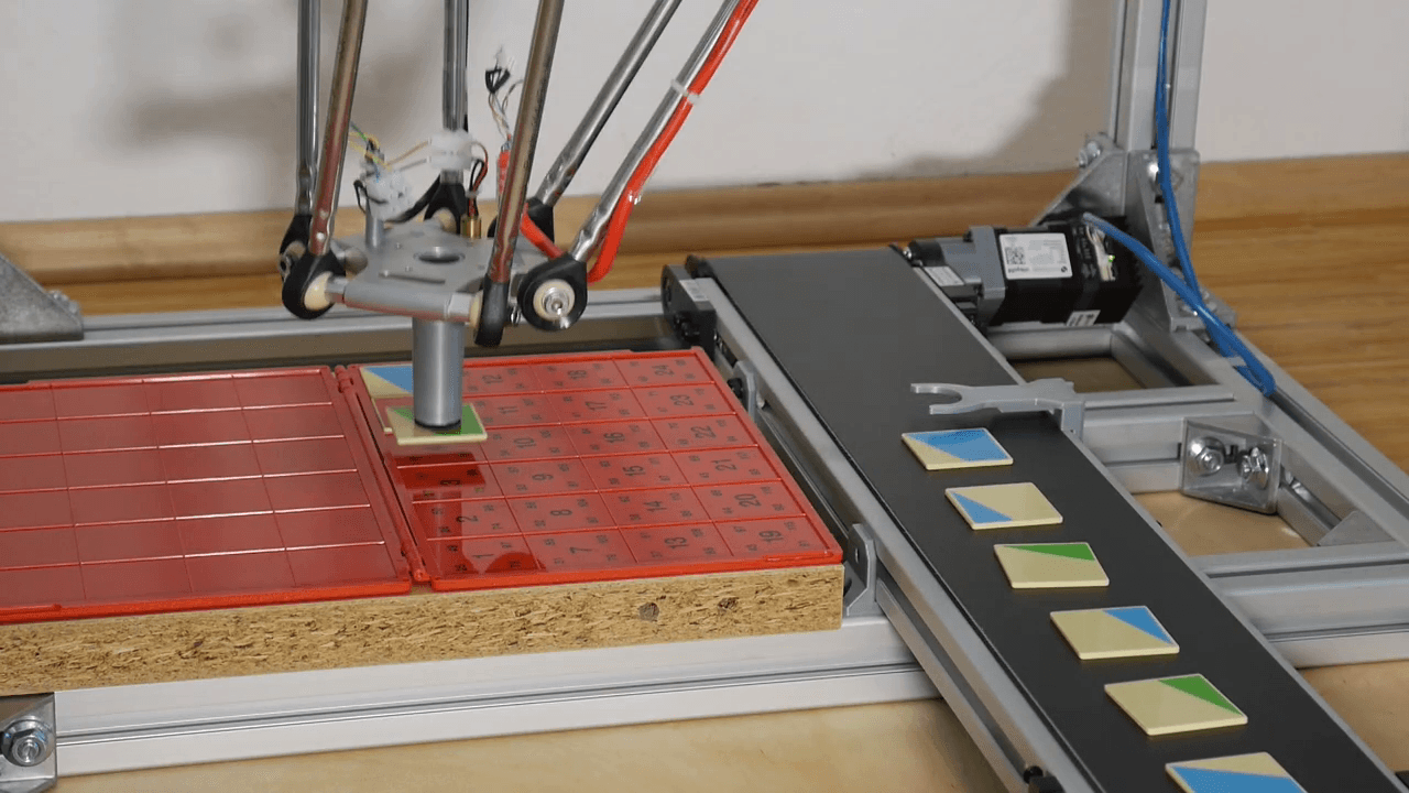 Delta robot sorts puzzle and lego pieces from conveyor belt